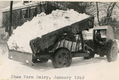 1949 – There was lots of snow that winter. Here the “Shaw Special” dumps a load of snow removed from the front of the barn.