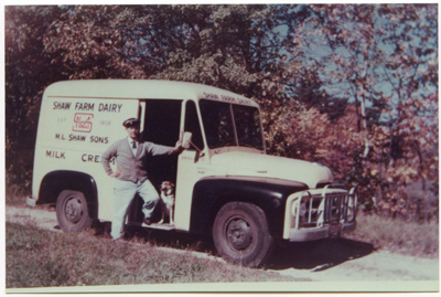 1950 – Albert Shaw with his dog, in front of a step-in milk truck.