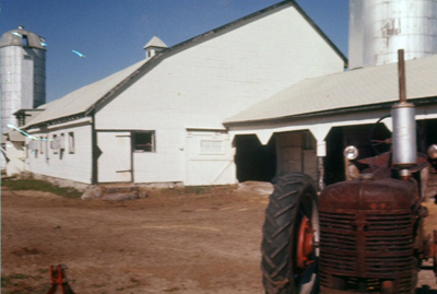1959 – Showing the barn, and the Farm-All Model H tractor used for years and years on the farm.